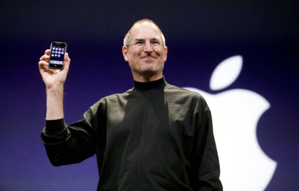 Стив Джобс держит первый iPhone на презентации в Сан-Франциско 2007