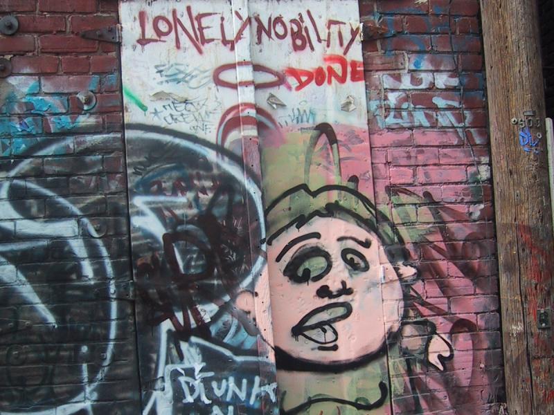 416 Grafitti Expo, Канада: дверь с мультяшным лицом и надписью 'LONELY NOBILITY'