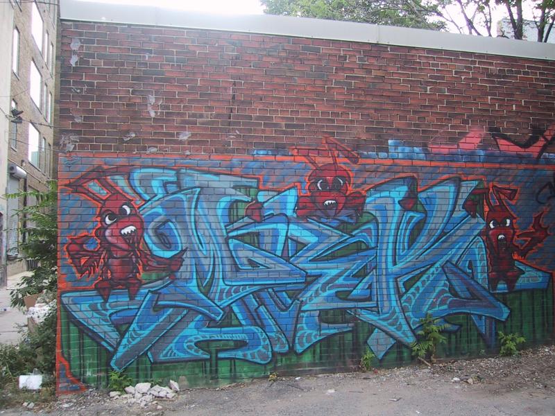 416 Grafitti Expo, Канада: синие брызги и красные муравьи на кирпичной стене