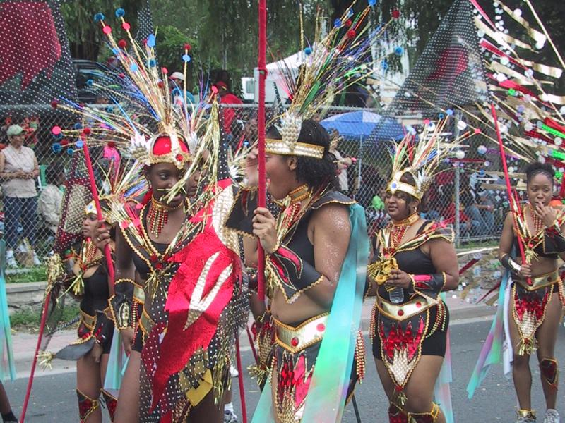 Caribana 2003 в Торонто: танцующие с золотыми перьями и красными бантами