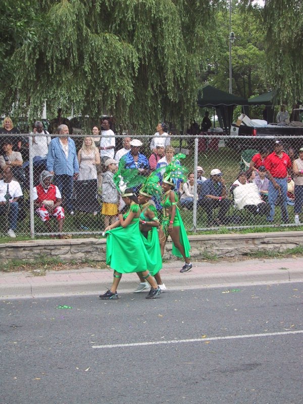 Caribana 2003 в Торонто: зелёные танцоры у забора с публикой