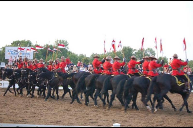 RCMP в красных мундирах на конной парадной ротации в Канаде