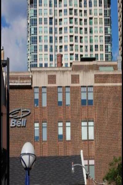 Торонто, 22 июля 2007: высотка за кирпичным зданием с вывеской Bell и центром TOEFL/TOEIC