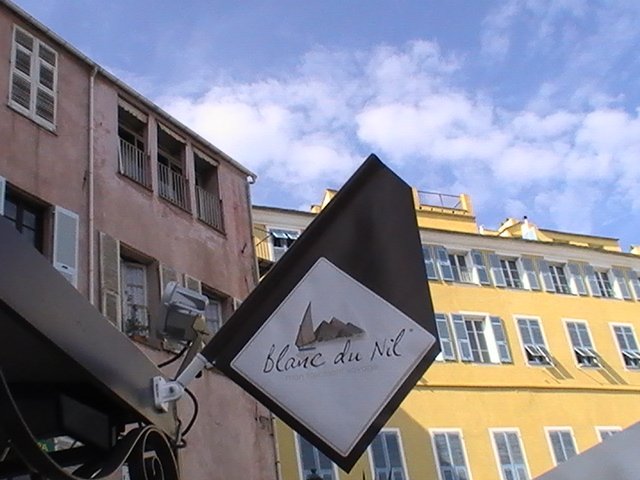 Ajaccio, 2008: вывеска «Blanc du Nil» на фоне розового и жёлтого фасадов