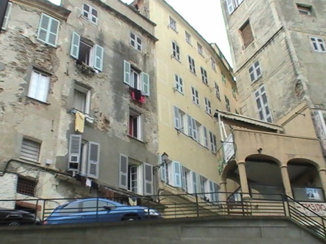 Ajaccio, 2008: старые дома с балконами и вывешенным бельём у подножия каменных аркад