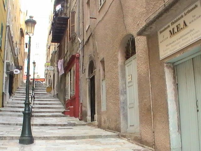 Ajaccio, 2008: каменные ступени между старыми домами и вывеской M.E.A.