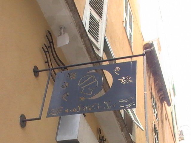 Ajaccio, 2008: вывеска с луной и звёздами у старого фасада