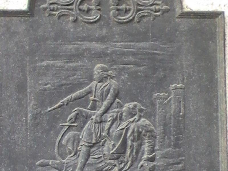 Памятная доска в Аяччо, 2008: сцена с мечом и пленником у крепости