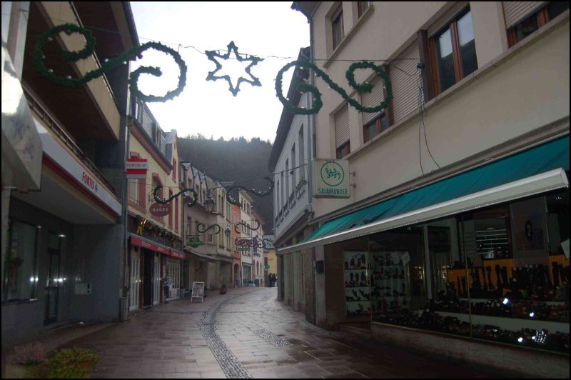 Улица в Clervaux, Люксембург: зелёные гирлянды над каменной мостовой