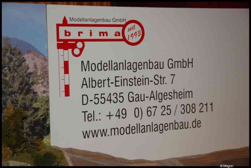 Expo train, Люксембург, 2010: вывеска Modellanlagenbau GmbH в ландшафте гор
