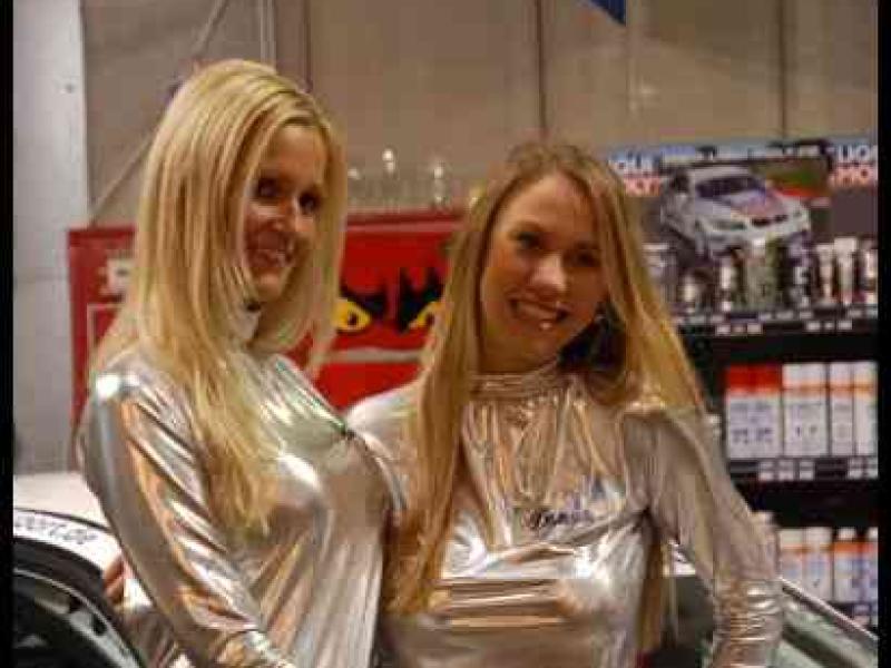 Motorshow 2010 в Люксембурге: две фигуры в серебристых костюмах у гоночного автомобиля