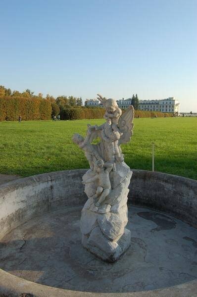 Архангельское, 2006: каменная скульптура в виде крылатого ангела с детьми на фоне парковой зелени