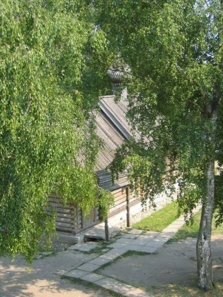 Старая Ладога, 2006: деревянная изба с резным козырьком и шатровой крышей