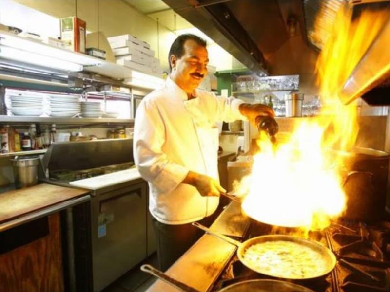 Pasta Freska, США: шеф в белом костюме поджигает сковороду над газовой плитой